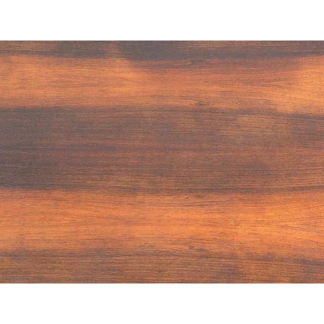 This rosewood and stainless steel coffee table has a reversible oiled rosewood and white formica top. This piece is...