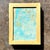 This small abstract painting features soft, layered strokes of turquoise, aqua, and pale sea-green, with subtle hints of...
