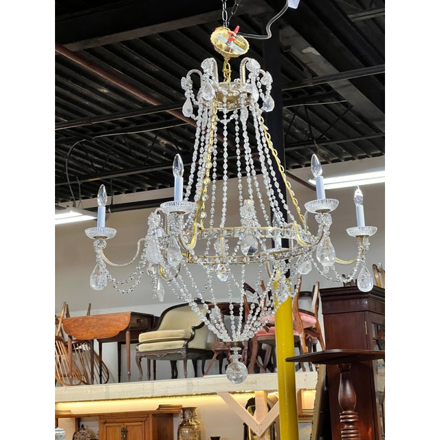 This vintage Empire style six-light chandelier is an elegant example of neoclassical revival design, combining classical...