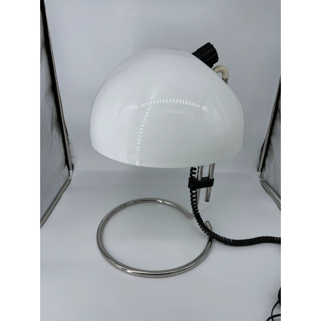 This stylish atomic table lamp is manufactured by Kartell in the 1970's, designed by Carlos Santi. Lamp is wired for use...