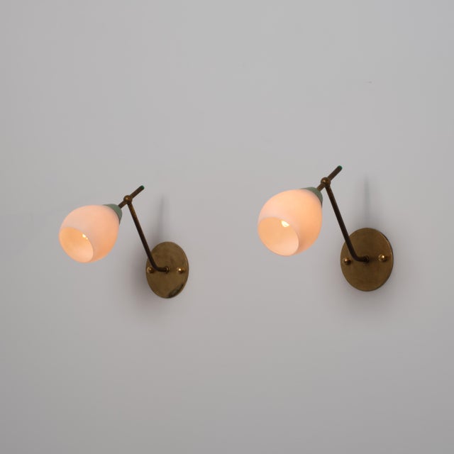 Pair of italian wall sconces dating from the 1950s, characterized by a slender and angular composition typical of mid-...
