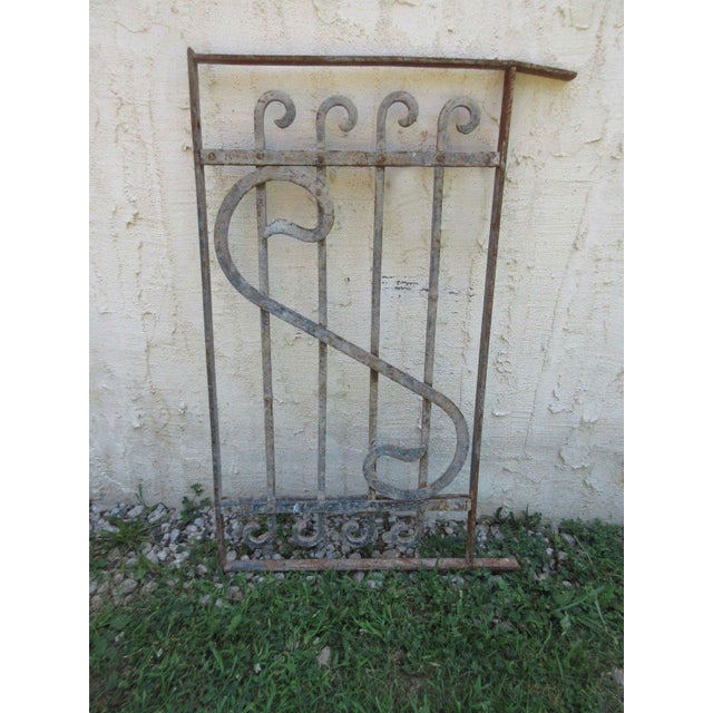 This iron gate/door is a wonderful piece of architecture. Heavy, tight, and sturdy. This piece does show signs of age...