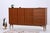 A large teak highboard with harmonious proportions and clean Danish lines. The combination of cabinet compartments,...