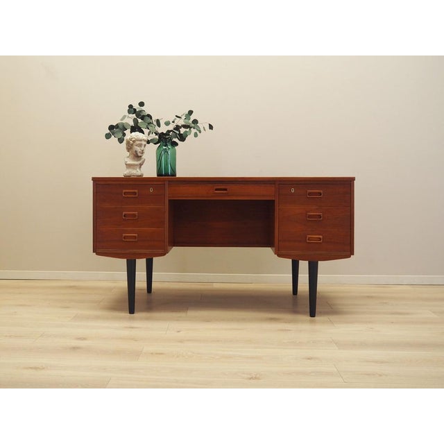 The desk was made in the 1970s, Danish production. The structure and the top are covered with teak veneer. The legs are...