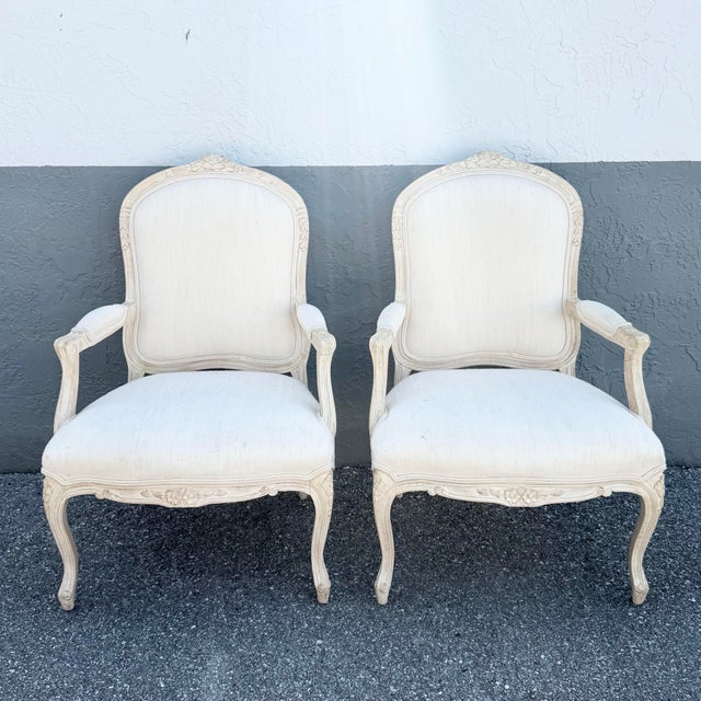 This elegant pair of French Provincial lounge chairs embodies timeless Louis XV-inspired design with graceful curves,...