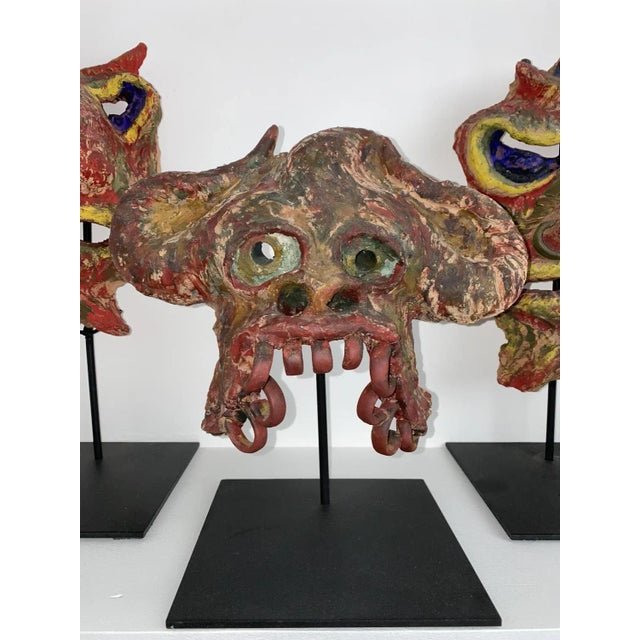 Angelo meani 1906-1977, very rare set of 3 art brut masks, in freehand painted terracotta and dated 1953. meani often...