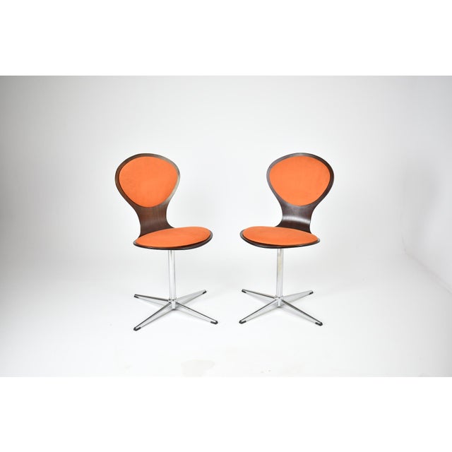 A rare and striking pair from one of postwar Germany's most celebrated furniture makers. These swivel chairs capture...