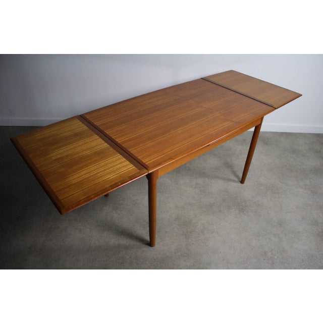 About this mid-century teak extension dining table attributed to Svend Madsen. This is a fine teak dining table. A must...