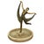 Art Deco style figural sculpture depicting a dancer in a flowing pose mounted at the center of a circular marble dish. The...