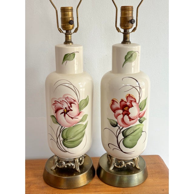 Pretty 1940s hand-painted boudoir lamp pair, with pink peony flowers and ornate brass bases. Please see condition details...