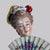 A fine antique Volkstedt porcelain figure, crafted circa 1890, depicting a finely dressed woman in the Rococo Revival...
