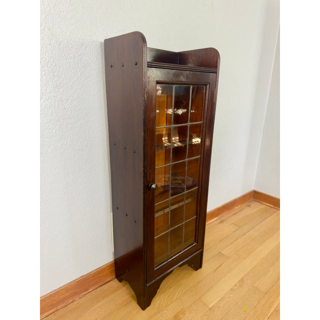 A remarkably slender antique glazed bookcase with the kind of warmth and character that can quietly transform a room....