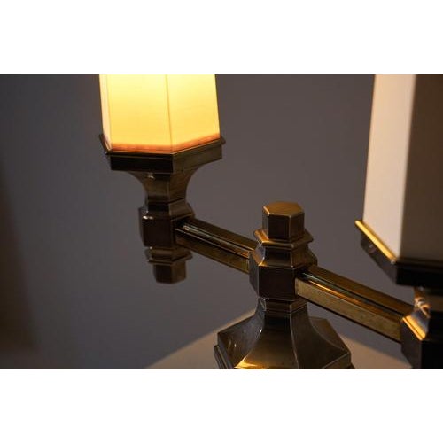 Scandinavian-style table lamp, crafted from chromed metal with gold accents. It features a sturdy base and a two-armed...