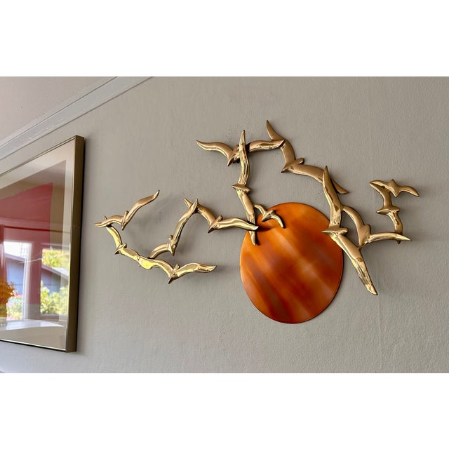 This is a vintage 3-dimensional Mid-Century Modern brutalist wall sculpture featuring polished brass seagulls in flight...
