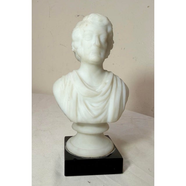 This antique Charles Sumner figural glass bust statue is a lovely statue made of a frosted white glass mounted to a black...