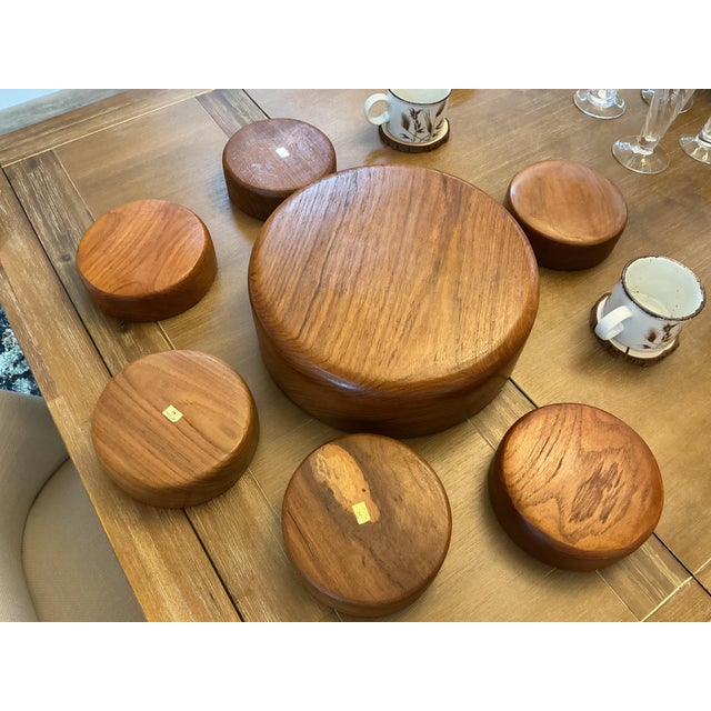 Elevate your tabletop with this iconic Mid-Century Modern 7-piece salad serving set crafted from solid, natural teak....