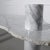Modern and Rare. Carrara marble table with an organic live edge table top and thick cylinder legs that transverse the...