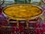 A vintage oval coffee table attributed to Theodore Alexander in a richly-figured burl and satinwood veneer arranged in a...