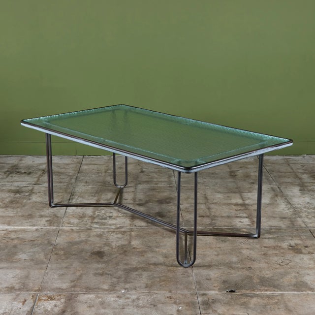 Dining table in patinated bronze designed by Walter Lamb and produced by Brown Jordan. The table has a rectangular shape...