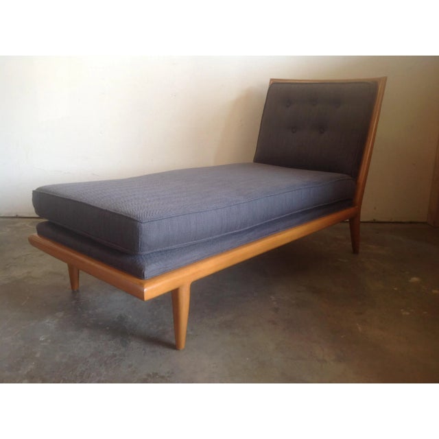Modern mid century style chaise lounge. Chaise is in the manner of Robsjohn Gibbings. Chaise has a light maple colored...