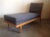 Modern mid century style chaise lounge. Chaise is in the manner of Robsjohn Gibbings. Chaise has a light maple colored...