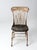 This is an antique spindle back chair. The rustic wooden farmhouse chair features a spindle back and metal braces. Aged...