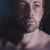 Sergei by Viktoria Savenkova | Oil on Canvas Portrait of a man with blue eyes For Sale