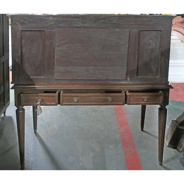 Antique, early 20th century, mirrored writing desk. This substantial desk has four tapered and turned legs and paneled...