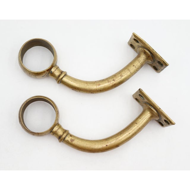 Reclaimed brass bar mount brackets designed to support rail tubing, commonly used for bar foot rails, handrails, or dance...
