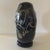 A three-layered, blown glass disc vase made of deep black glass paste, adorned with abstract motifs in hot-applied silver...