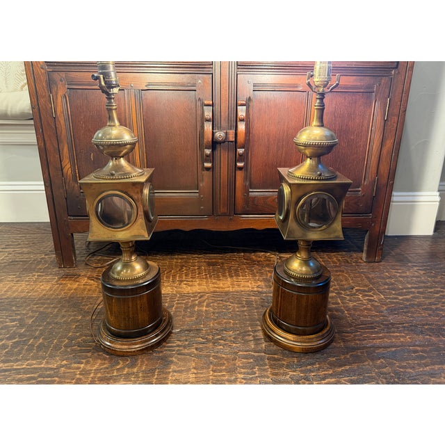 Striking pair of vintage Frederick Cooper table lamps featuring an unusual nautical lantern-inspired design in aged brass,...