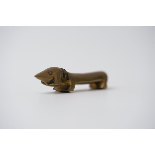 Object: Bottle opener in the shape of a dachshund Designer: Walter Bosse (1904–1979) Age: 1950s/1960s Material: Brass...