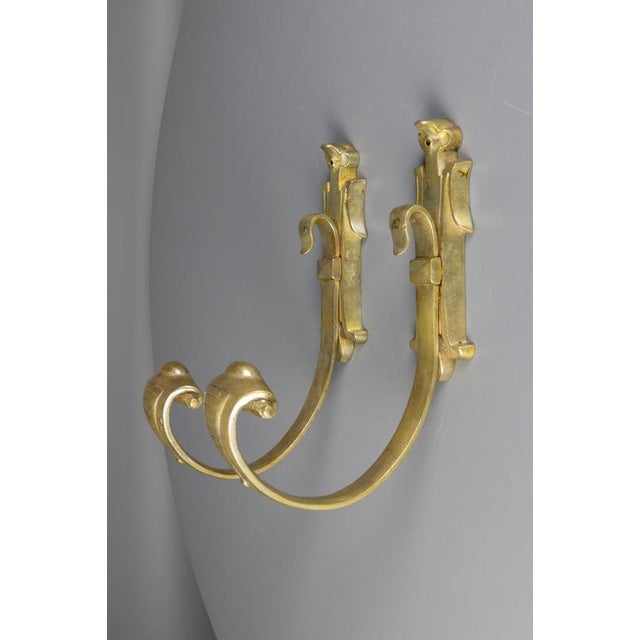 Pair of French bronze curtain tiebacks, early 20th century. Elegant bronze curtain tiebacks featuring gracefully curved...