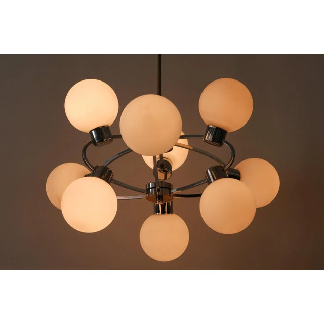 Spectacular mid-century modern nine-armed sputnik multi-globe chandelier or pendant light 'orbit'. Designed and...