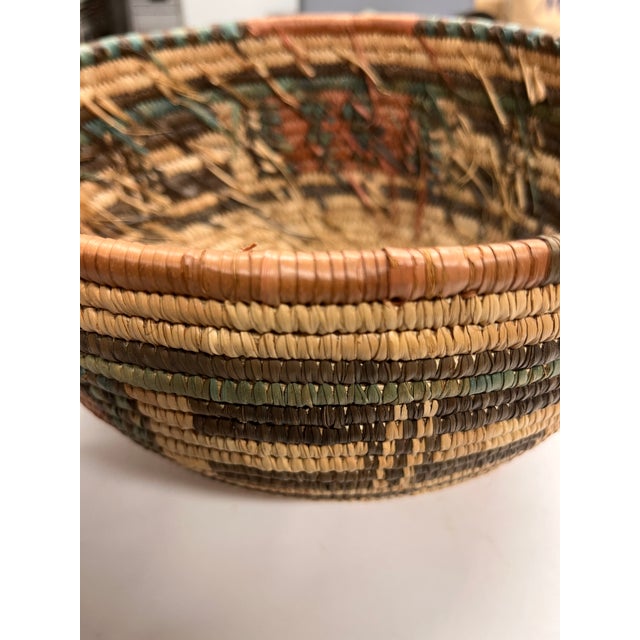 Beautiful earth toned basket, hand woven, from Africa. Geometric patterns in brown, orange and turquoise. Hold towels in...