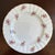 Offering a lovely vintage fine bone china dessert plate, made in England. This charming plate features delicate sprays of...