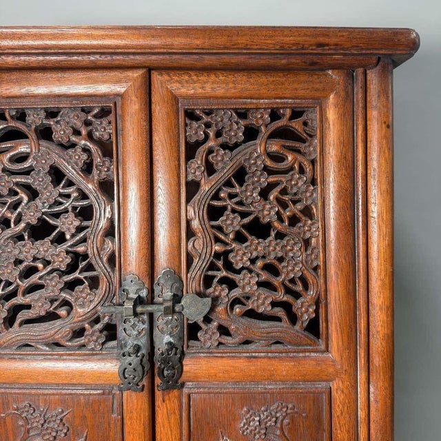 Presenting a spectacular vintage Chinese carved hardwood cabinet, an exceptional piece of traditional Asian furniture....