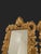 Pair of small rectangular mirrors in carved and gilded wood, richly decorated with foliage, rocaille scrolls, and a shell...
