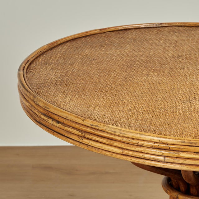 Impressive vintage Italian table with a round top covered in grasscloth framed in bamboo on a pedestal with dramatic bent...