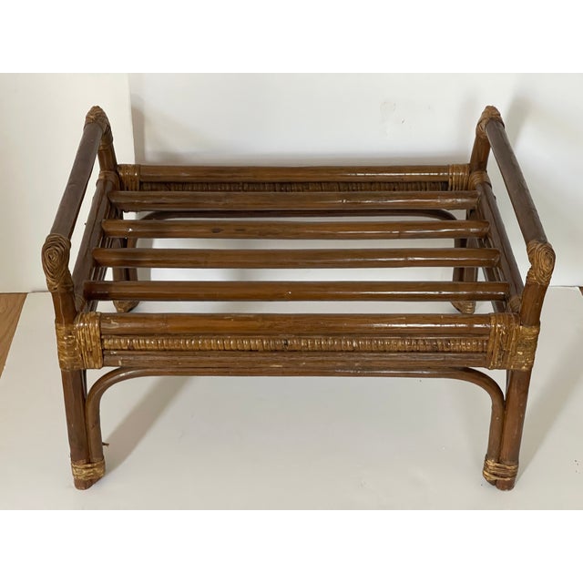 Vintage bamboo ottoman with banana leaves upholstery.