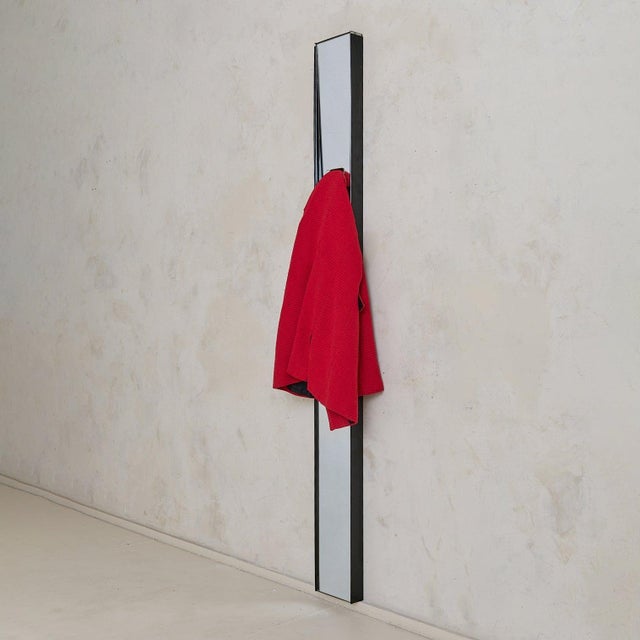 The ‘Gronda’ wall mirror and coat rack was designed in 1972 by Luciano Bertoncini and produced by Elco under the creative...