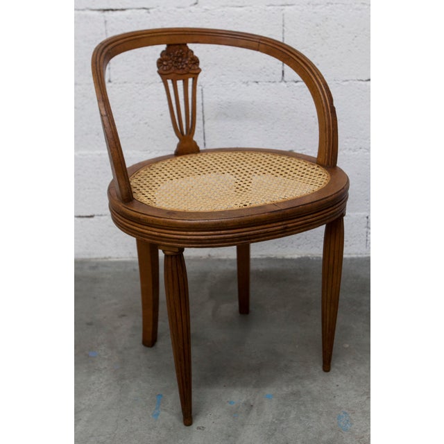 Elegant vintage chair (1900s–1930s) in carved wood, with a lovely lyre-shaped back and caned seat (hand-woven caning) in...