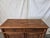 Late 19th-century European provincial sideboard or farmhouse cabinet crafted from richly grained solid pine. This rustic...