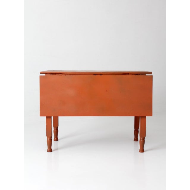 An early 20th century farmhouse drop leaf table with simple turned legs and compact proportions suited for cottage,...