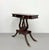 A vintage Regency-style side table crafted in a rich mahogany finish, featuring a rectangular top with softly rounded...