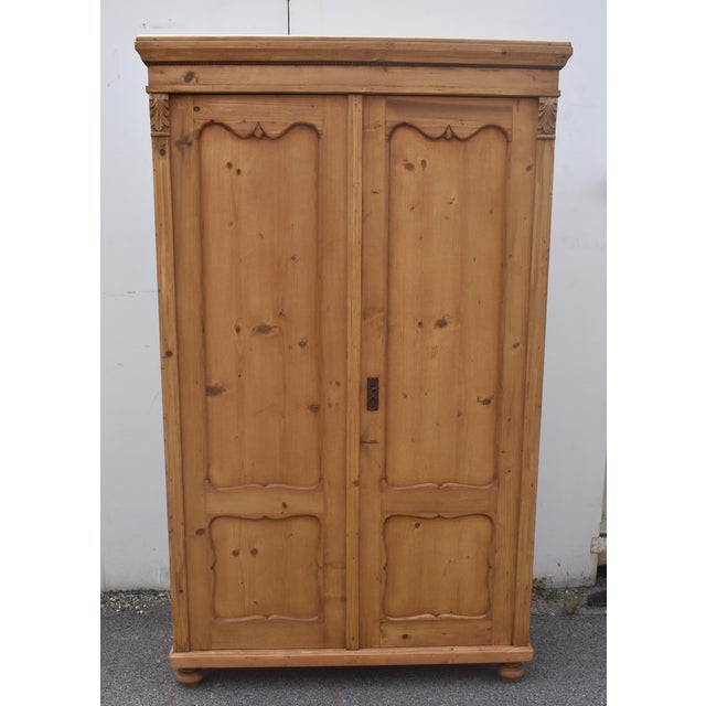 This sturdy two door armoire has a heavy hand-planed crown molding above a plain frieze and bead. The two doors each have...