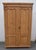 This sturdy two door armoire has a heavy hand-planed crown molding above a plain frieze and bead. The two doors each have...