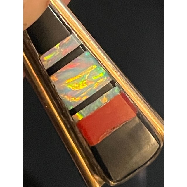 Mary Livingston sterling silver pendant with inlaid onyx, black opal, and coral, signed ‘ML’. Features inlaid stones...