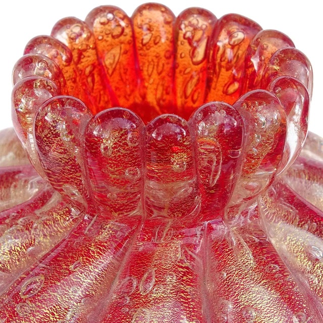 Beautiful vintage Murano hand blown ruby red and gold flecks Italian art glass ribbed flower bud vase. The piece is...
