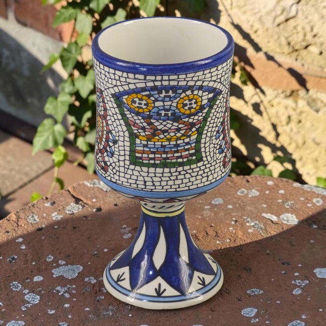 This hand-painted Armenian ceramic chalice features a unique loaves and fish mosaic motif, reflecting the spiritual...